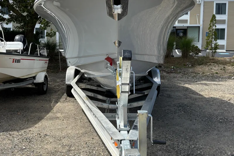 Slide: The Image of 2026 Sea Hunt Gamefish 25 boat on trailer, parked outdoors. - 13