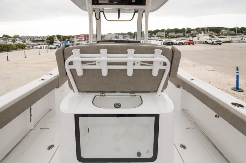 Slide: The Image of 2026 Sea Hunt Gamefish 25 boat interior with rod holders and storage compartment. - 5