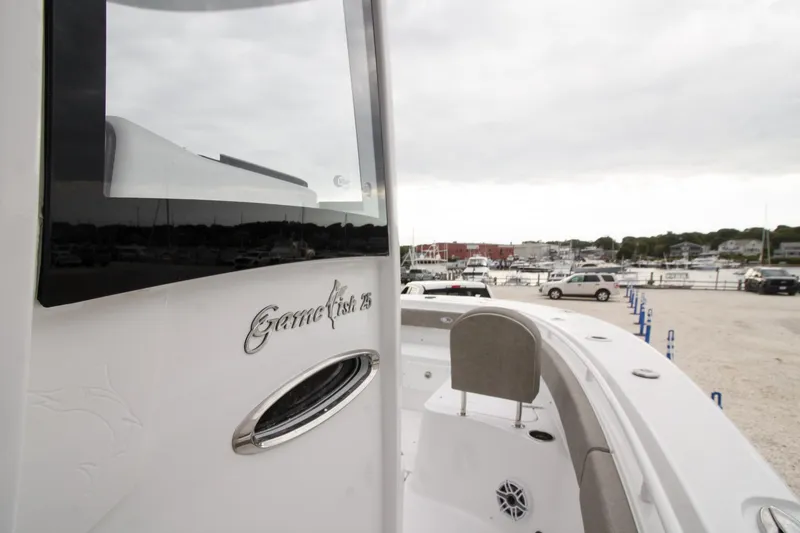 Slide: The Image of 2026 Sea Hunt Gamefish 25 boat docked at marina, showcasing sleek design. - 8