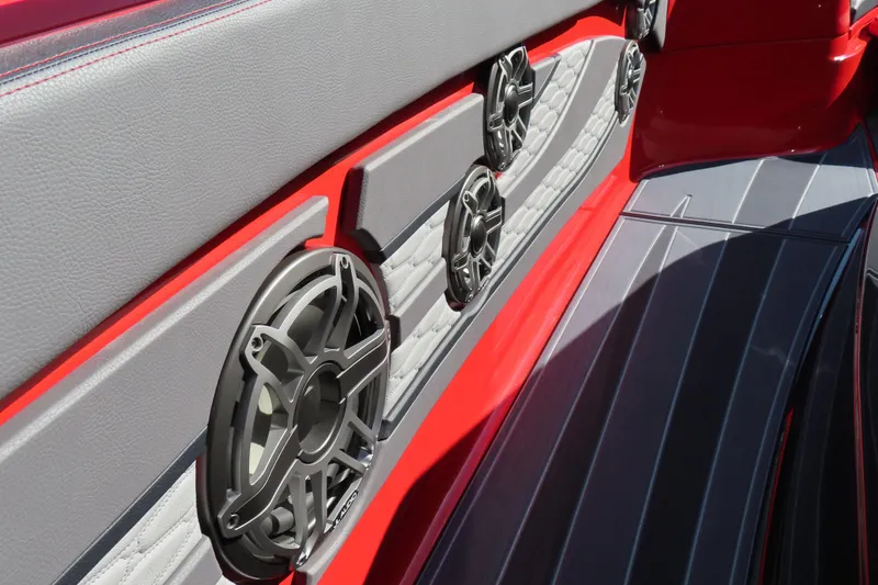 Slide: The Image of Interior of 2026 MTI 42 v boat with sleek red and gray design, featuring speakers. - 13