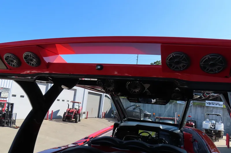 Slide: The Image of Red MTI 42 v boat with speakers, 2026 model, in a service area. - 21