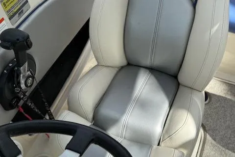 Slide: The Image of 2010 Sea Ray 185 Sport boat interior with steering wheel and control panel. - 7