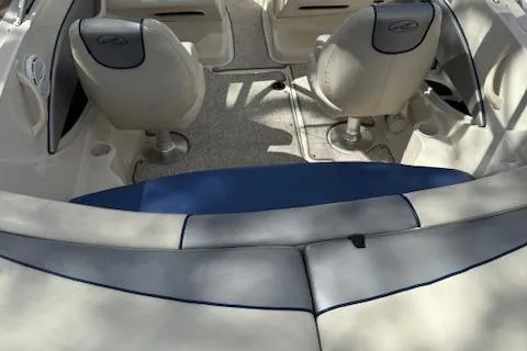 Slide: The Image of 2010 Sea Ray 185 Sport boat interior with beige and blue seating. - 8