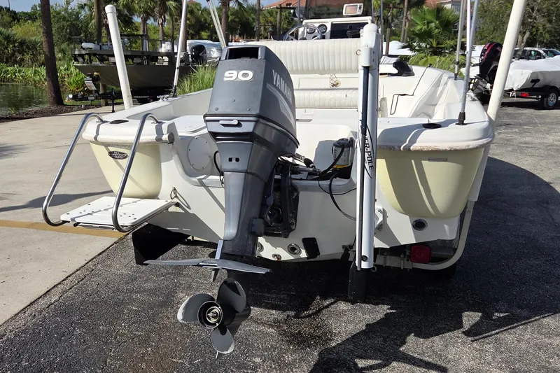 Slide: The Image of 2005 NauticStar 1800 Nautic Bay boat with Yamaha 90 outboard motor, parked outdoors. - 3