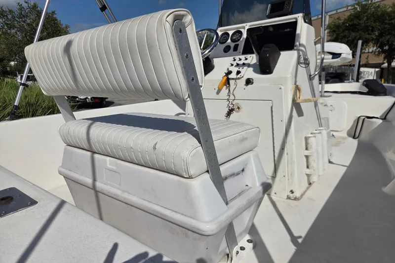 Slide: The Image of 2005 NauticStar 1800 Nautic Bay boat interior with white seating and control panel. - 4