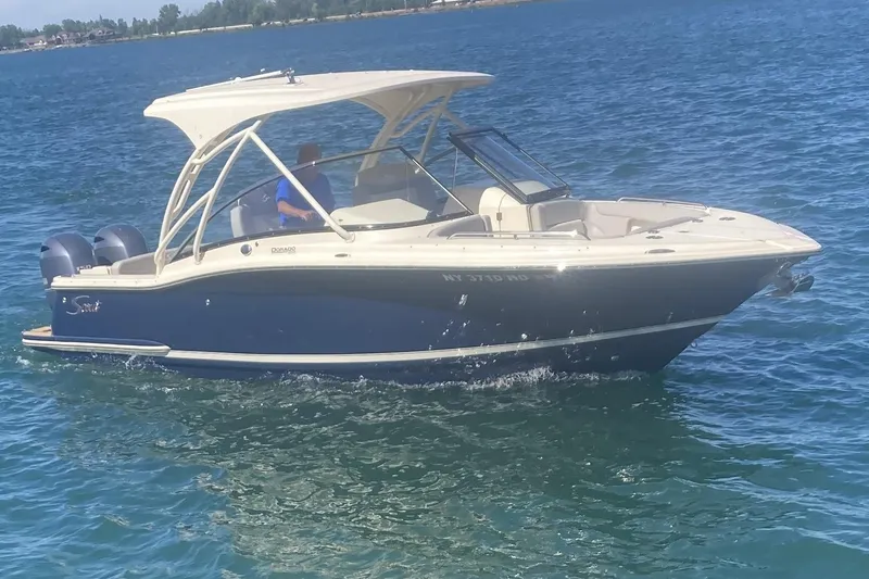 The Image of 2021 Scout 255 Dorado boat cruising on clear blue water. - 0