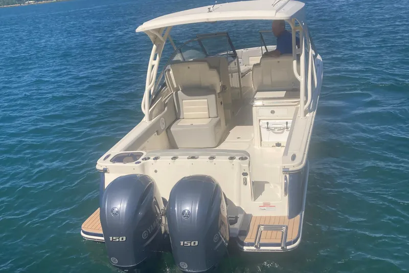 Slide: The Image of 2021 Scout 255 Dorado boat with dual engines on open water. - 2