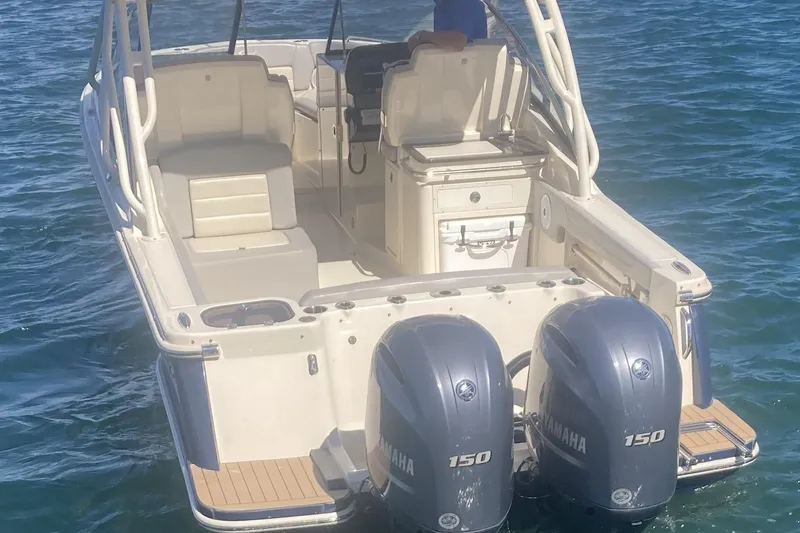 Slide: The Image of 2021 Scout 255 Dorado boat with dual Yamaha 150 engines on water. - 3