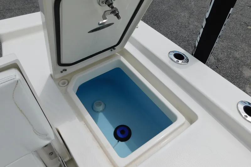 Slide: The Image of 2026 Pathfinder 2200 TRS boat livewell with open lid, showcasing interior design. - 11