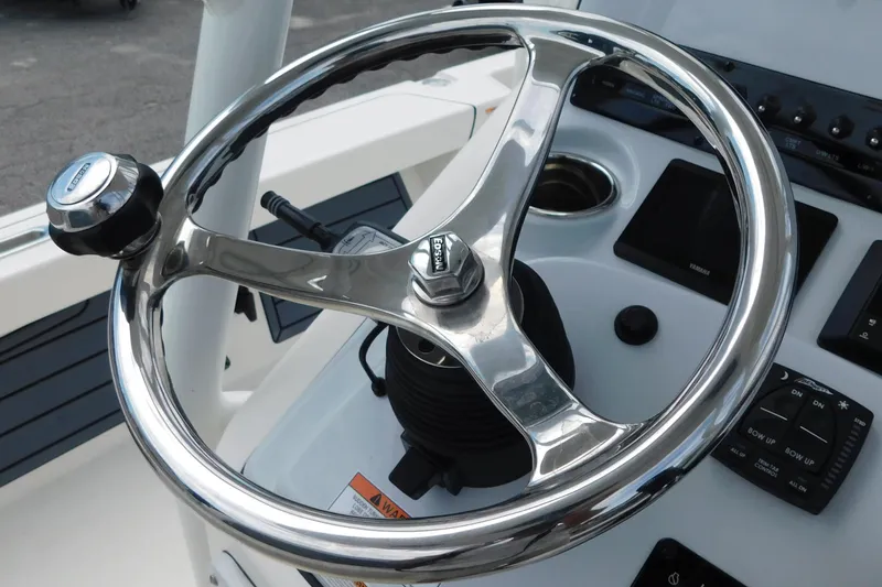 Slide: The Image of Steering wheel of 2026 Pathfinder 2200 TRS boat, featuring modern controls and sleek design. - 18