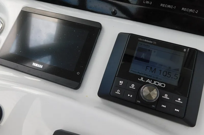 Slide: The Image of Yamaha display and JL Audio MediaMaster S5 on 2026 Pathfinder 2200 TRS boat console. - 19