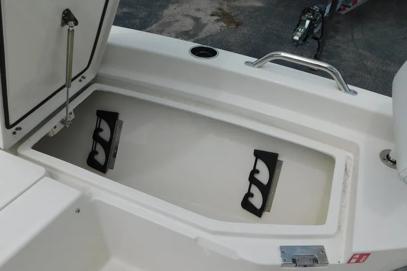 Slide: The Image of Open storage compartment on 2026 Pathfinder 2200 TRS boat, featuring secure latch and hydraulic support. - 23
