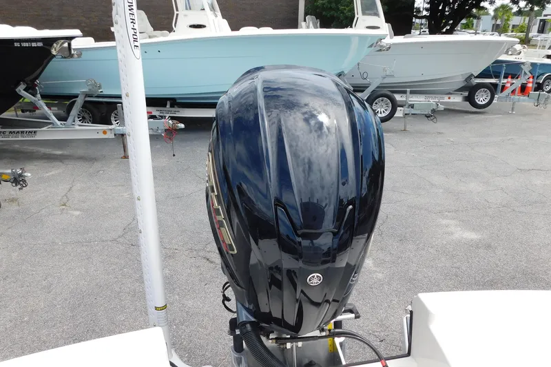 Slide: The Image of 2026 Pathfinder 2200 TRS boat with Yamaha outboard motor, parked on a trailer. - 25