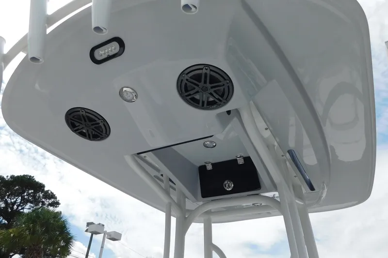 Slide: The Image of 2026 Pathfinder 2200 TRS boat T-top with speakers and storage, viewed from below. - 26