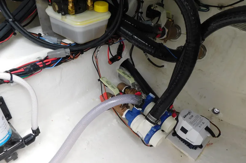 Slide: The Image of Interior view of 2026 Pathfinder 2200 TRS boat showing wiring and plumbing components. - 34