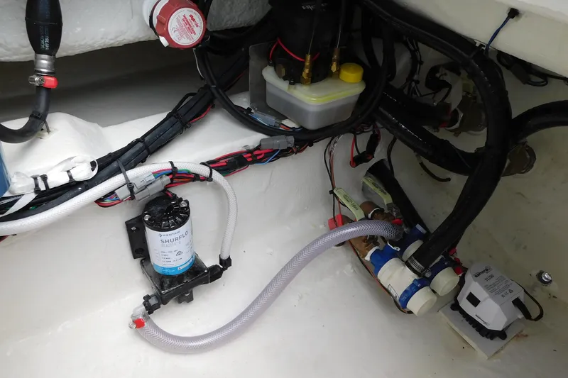 Slide: The Image of 2026 Pathfinder 2200 TRS boat interior wiring and pump system close-up. - 35