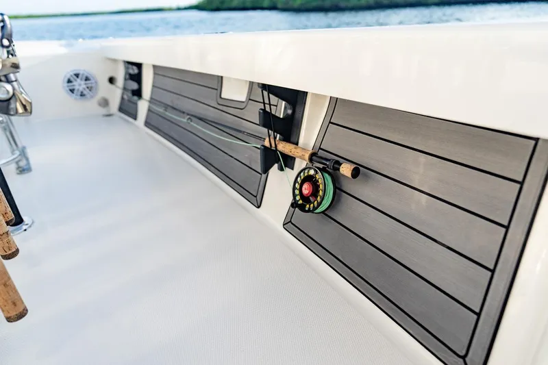 Slide: The Image of 2026 Pathfinder 2200 TRS boat interior with fishing rod holder and sleek design. - 44