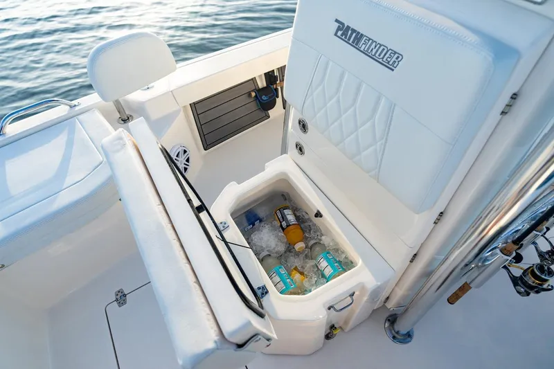 Slide: The Image of 2026 Pathfinder 2200 TRS boat with open cooler, drinks, and ice on deck. - 49