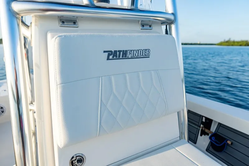 Slide: The Image of 2026 Pathfinder 2200 TRS boat seat with logo, on calm water background. - 50