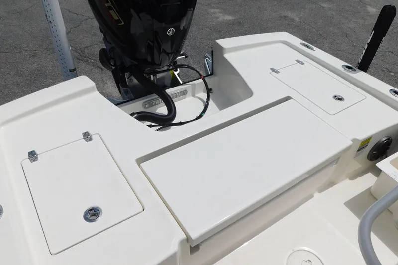 Slide: The Image of 2026 Pathfinder 2200 TRS boat deck with storage compartments and motor. - 8