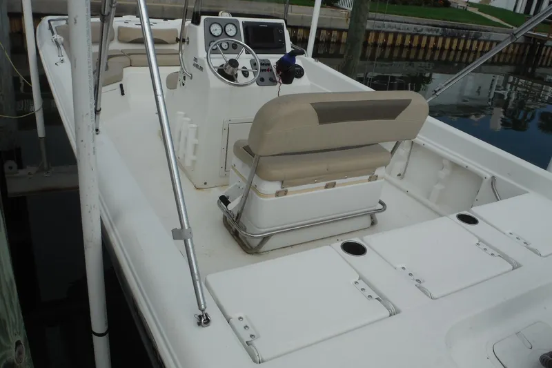 Slide: The Image of 2014 NauticStar 210 Angler boat interior with steering console and seating. - 14