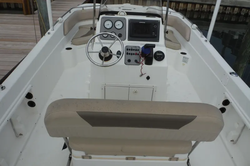 Slide: The Image of 2014 NauticStar 210 Angler boat interior with steering wheel and control panel. - 15