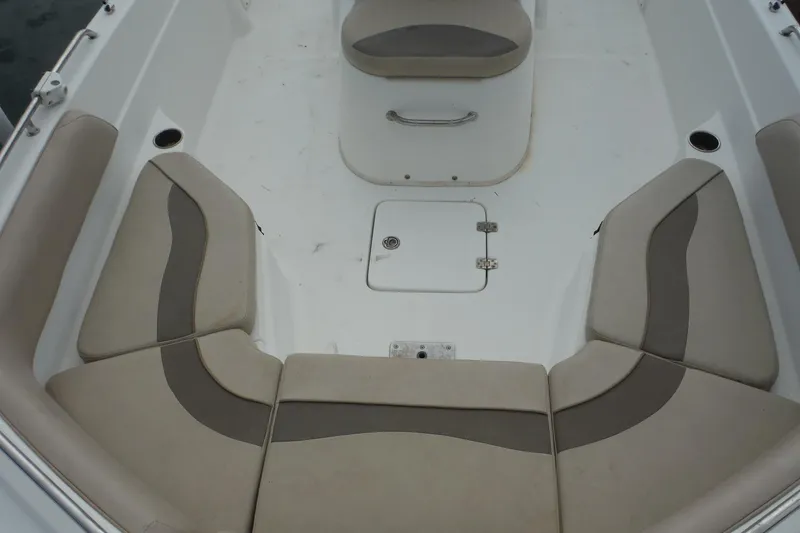 Slide: The Image of 2014 NauticStar 210 Angler boat interior with cushioned seating and storage hatch. - 19