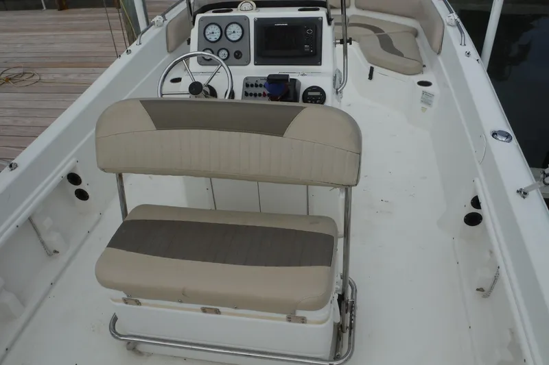 Slide: The Image of 2014 NauticStar 210 Angler boat interior with seating and control panel. - 22