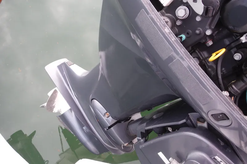 Slide: The Image of Outboard motor of 2014 NauticStar 210 Angler boat, docked on calm water. - 27