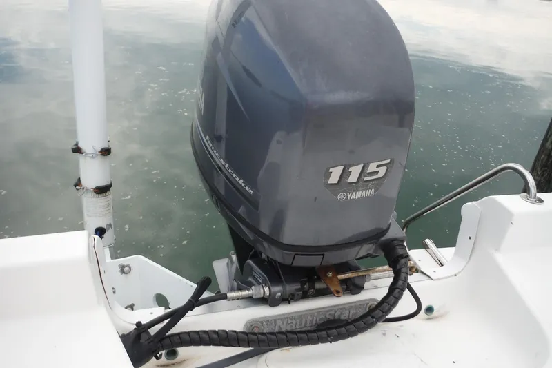 Slide: The Image of 2014 NauticStar 210 Angler with Yamaha 115 outboard motor on calm water. - 29