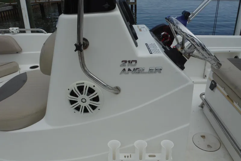 Slide: The Image of 2014 NauticStar 210 Angler boat interior with steering wheel and speaker. - 32