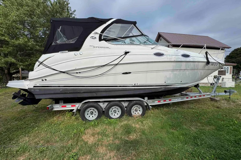 Slide: The Image of 2007 Sea Ray 280 Sundancer boat on trailer, parked on grass near house. - 0