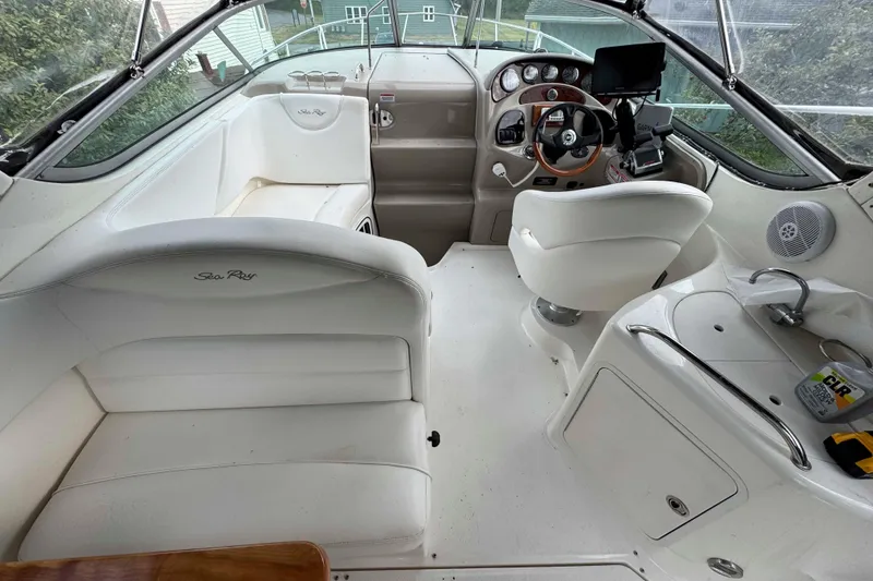 Slide: The Image of Interior of 2007 Sea Ray 280 Sundancer boat with white seating and helm. - 3