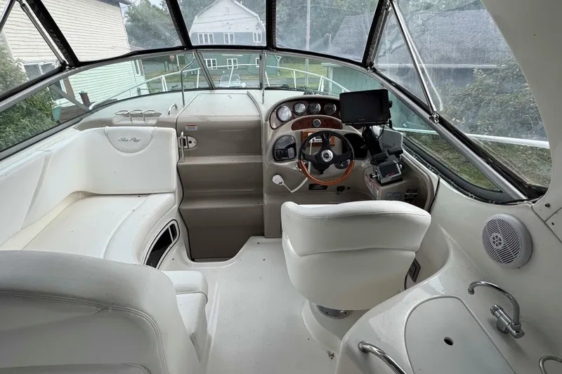 Slide: The Image of 2007 Sea Ray 280 Sundancer cockpit with steering wheel, seating, and navigation equipment. - 5