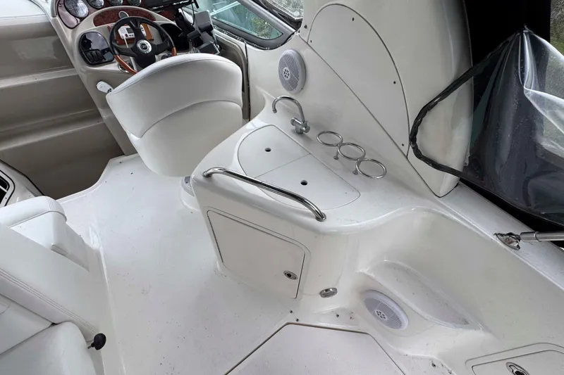 Slide: The Image of 2007 Sea Ray 280 Sundancer cockpit with helm, sink, and cup holders. - 6