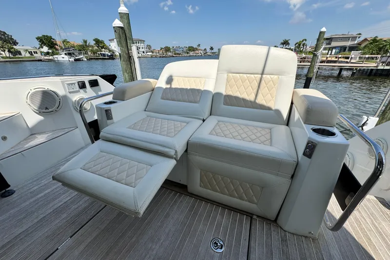 Slide: The Image of Luxurious seating on 2018 Beneteau Gran Turismo 46 yacht, featuring quilted upholstery and cup holders. - 12