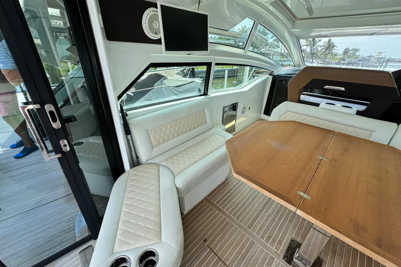 Slide: The Image of Luxurious interior of 2018 Beneteau Gran Turismo 46 yacht with elegant seating and wooden table. - 16