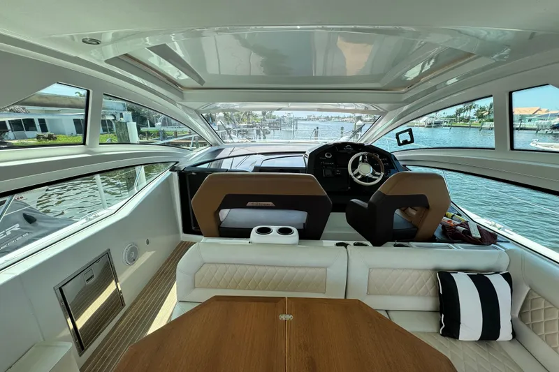 Slide: The Image of Interior view of 2018 Beneteau Gran Turismo 46 yacht, featuring helm and seating area. - 18