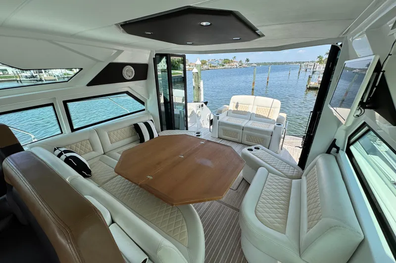 Slide: The Image of Luxurious interior of 2018 Beneteau Gran Turismo 46 yacht with elegant seating and scenic water view. - 22