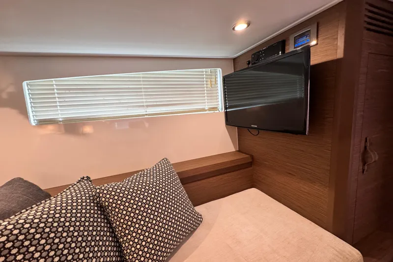 Slide: The Image of Interior of 2018 Beneteau Gran Turismo 46 yacht with TV, window blinds, and cozy seating. - 36