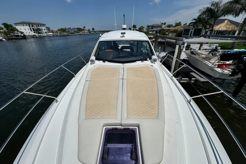 Slide: The Image of 2018 Beneteau Gran Turismo 46 yacht on a serene waterfront dock. - 43