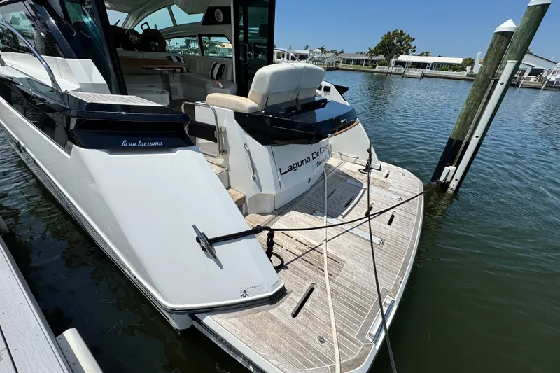 Slide: The Image of 2018 Beneteau Gran Turismo 46 yacht docked at marina, rear view. - 7