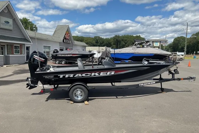 The Image of 2025 Tracker Pro Team 175 boat displayed at dealership under blue sky. - 1