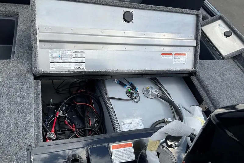 Slide: The Image of 2025 Tracker Pro Team 175 boat interior showing battery compartment and wiring setup. - 12