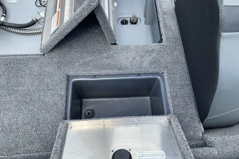 Slide: The Image of 2025 Tracker Pro Team 175 boat interior with storage compartments and carpeted flooring. - 15