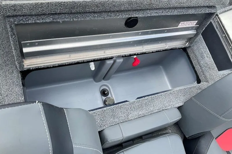Slide: The Image of 2025 Tracker Pro Team 175 boat storage compartment with gray interior and seating. - 17