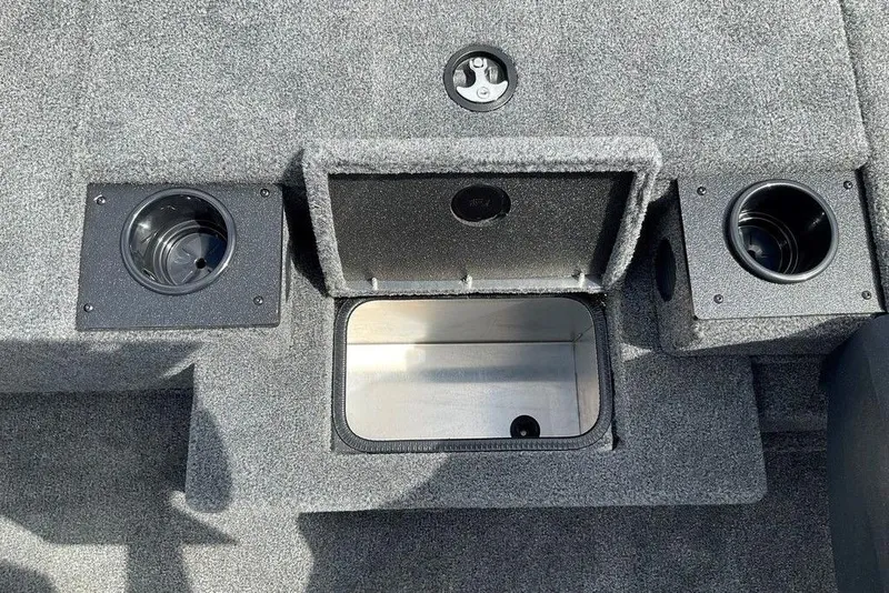 Slide: The Image of 2025 Tracker Pro Team 175 boat interior with cup holders and storage compartment. - 19