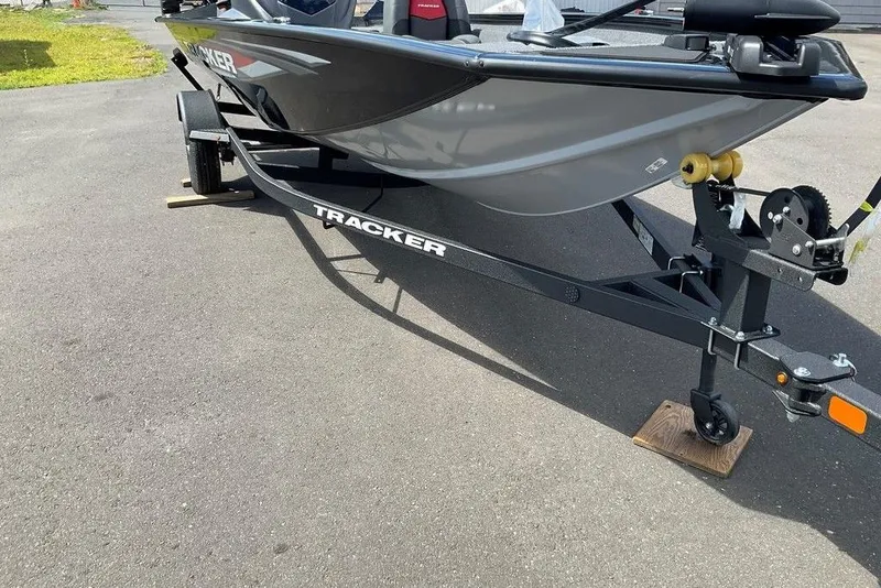 Slide: The Image of 2025 Tracker Pro Team 175 boat on trailer, parked on asphalt. - 32