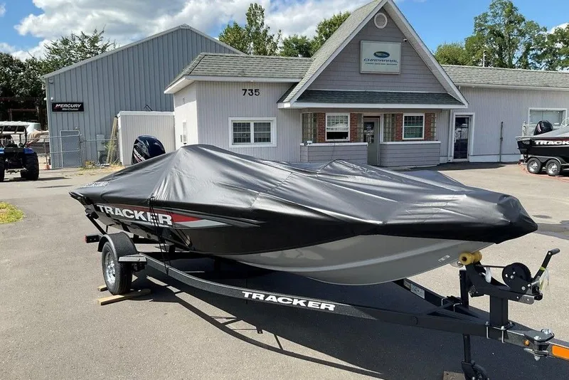 Slide: The Image of 2025 Tracker Pro Team 175 boat covered, parked outside dealership. - 37