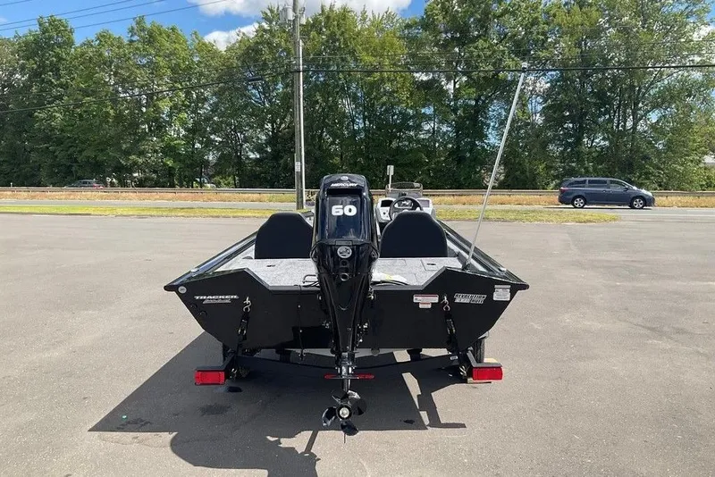 Slide: The Image of 2025 Tracker Pro Team 175 boat with outboard motor in parking lot. - 4